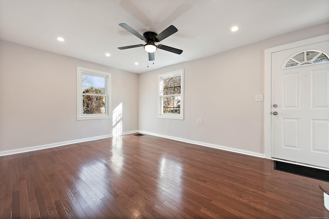 interior space with ceiling fan and dark wood-type flooring