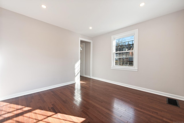 spare room with dark hardwood / wood-style floors