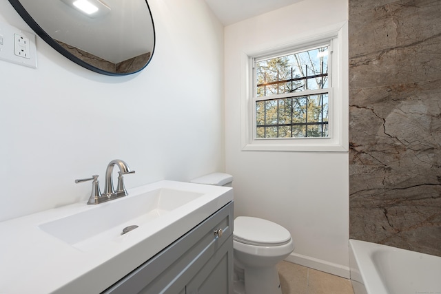 bathroom featuring tile patterned floors, vanity, toilet, and a bath