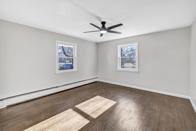 spare room featuring ceiling fan, a baseboard radiator, and dark hardwood / wood-style floors