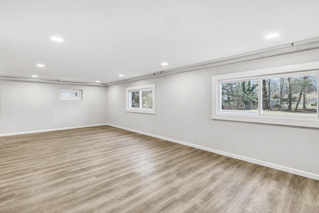 unfurnished room with light wood-type flooring and a wealth of natural light