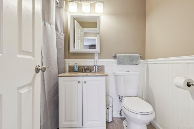 bathroom with tile patterned flooring, vanity, and toilet