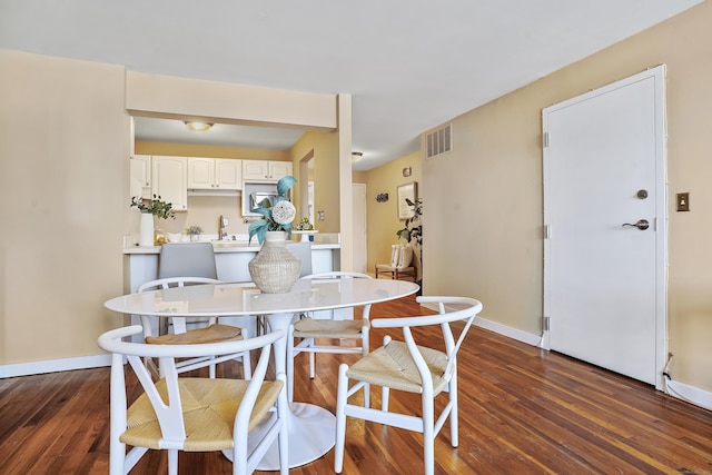 dining room with dark hardwood / wood-style flooring