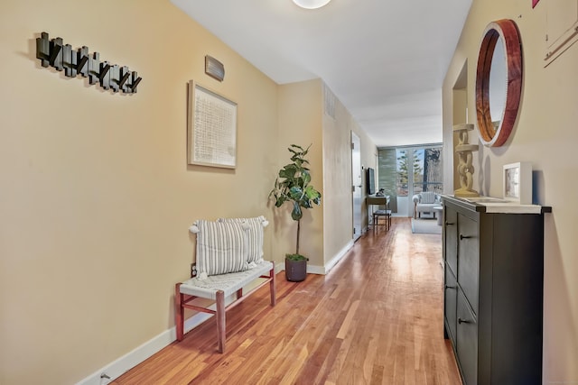 corridor with light hardwood / wood-style flooring