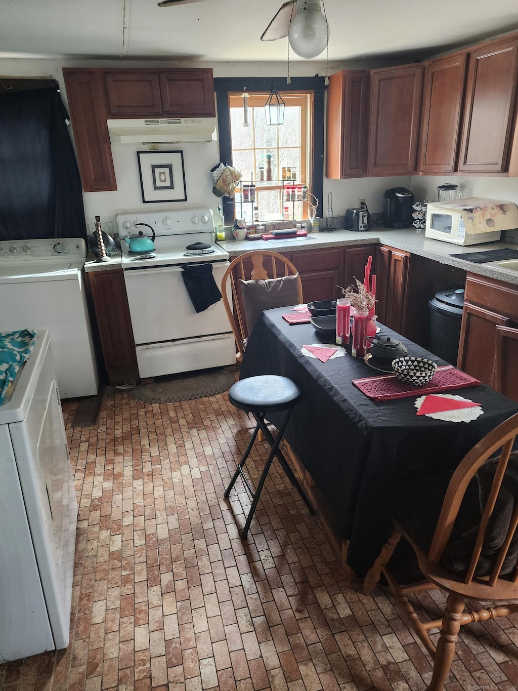 kitchen featuring white appliances and washer / clothes dryer