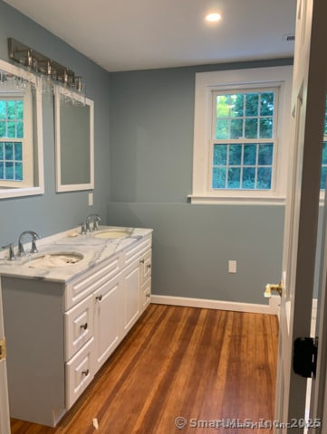 bathroom with vanity and hardwood / wood-style floors