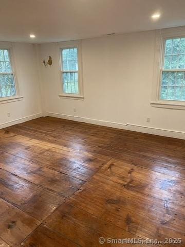 spare room with dark hardwood / wood-style flooring