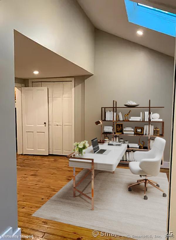 office area featuring high vaulted ceiling and light hardwood / wood-style floors