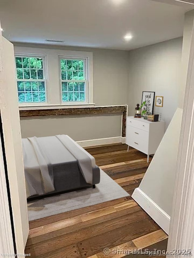 bedroom featuring dark hardwood / wood-style flooring