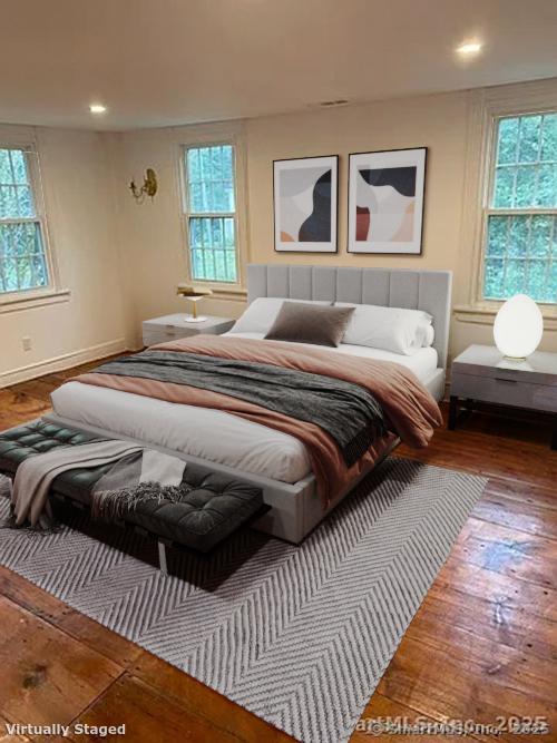 bedroom featuring wood-type flooring and multiple windows