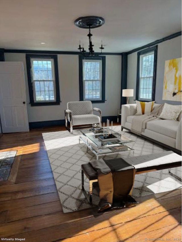 living room featuring ornamental molding, hardwood / wood-style floors, and a notable chandelier