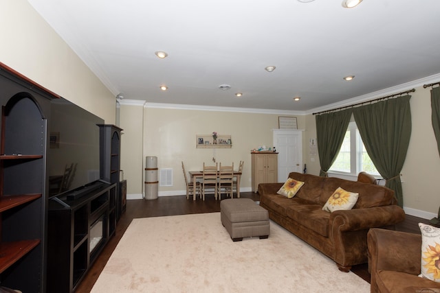 living room featuring crown molding and hardwood / wood-style flooring