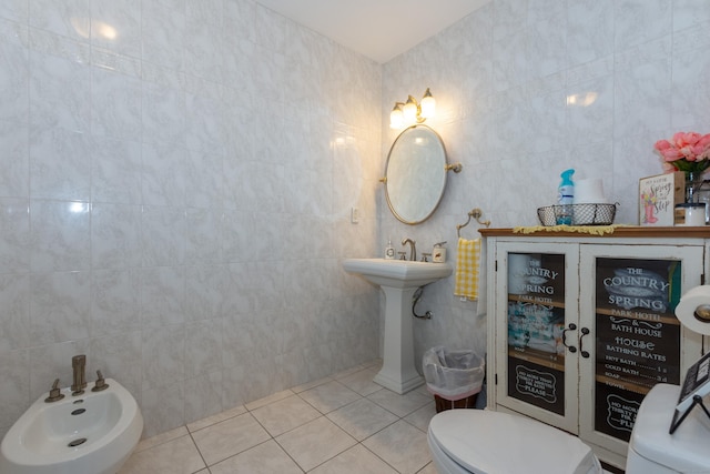 bathroom featuring tile patterned flooring, toilet, and tile walls