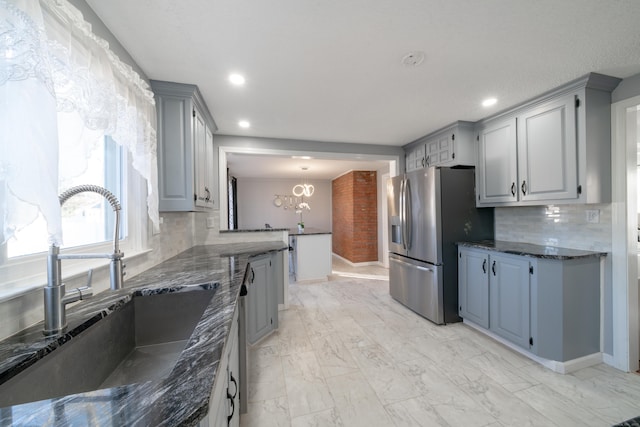 kitchen with stainless steel appliances, tasteful backsplash, gray cabinetry, and sink