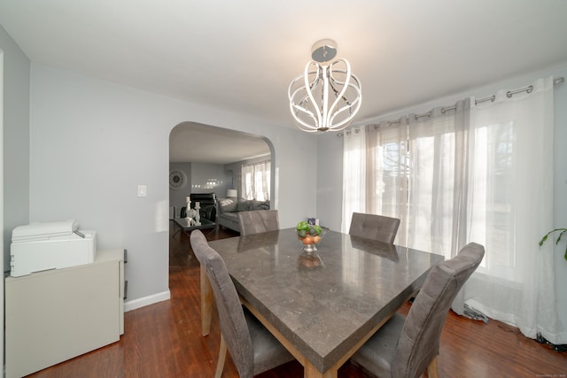 dining room featuring a chandelier and dark wood-type flooring