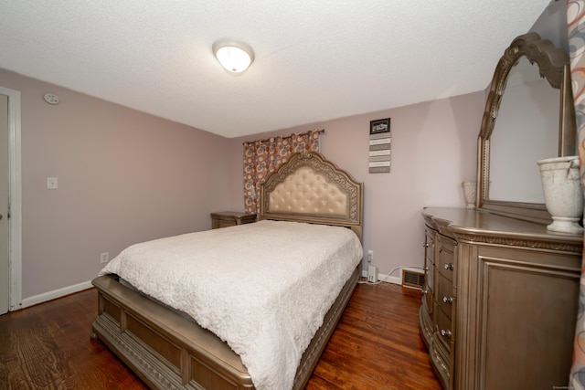 bedroom with dark hardwood / wood-style flooring