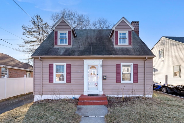 cape cod-style house with a front lawn