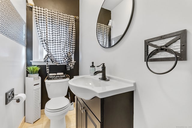 bathroom featuring toilet, vanity, and tile patterned floors