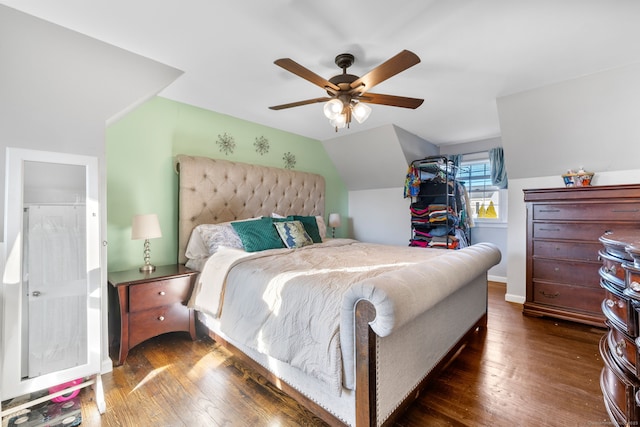 bedroom with vaulted ceiling, ceiling fan, and dark hardwood / wood-style floors