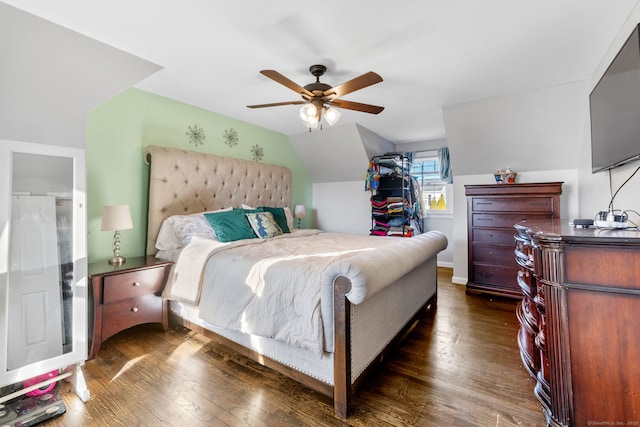 bedroom with ceiling fan, dark hardwood / wood-style floors, and lofted ceiling