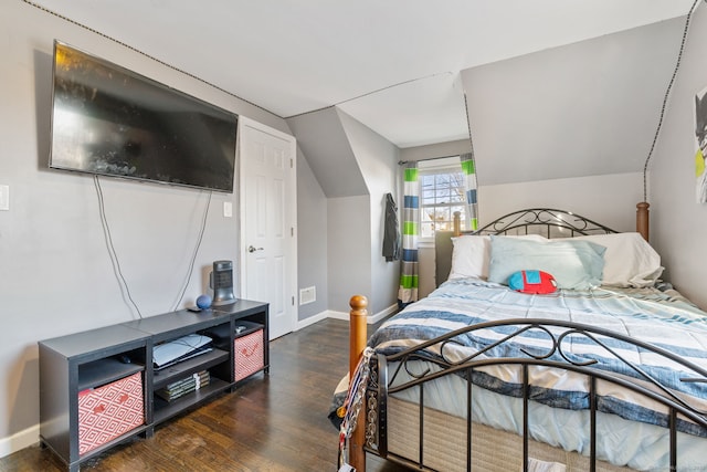 bedroom featuring lofted ceiling and dark hardwood / wood-style floors