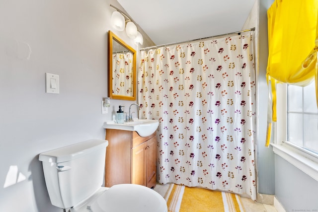 bathroom featuring vanity, toilet, and curtained shower