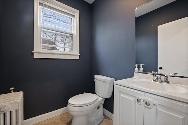 bathroom with radiator, tile patterned flooring, vanity, and toilet