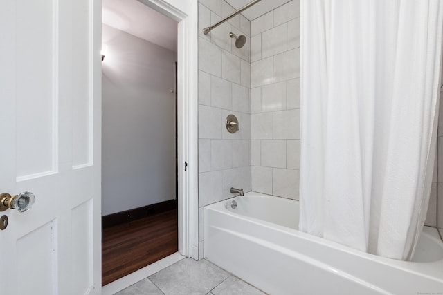 bathroom with shower / bath combo and tile patterned floors