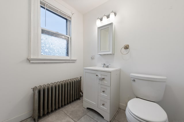 bathroom featuring tile patterned flooring, vanity, toilet, and radiator