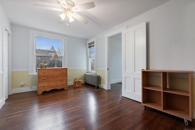 bedroom featuring ceiling fan, dark hardwood / wood-style floors, and radiator heating unit