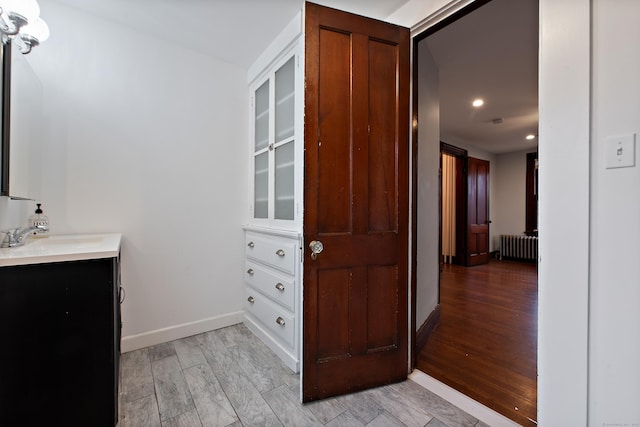 bathroom with vanity and radiator