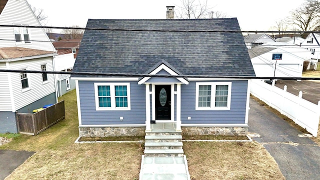 bungalow-style house featuring a front yard