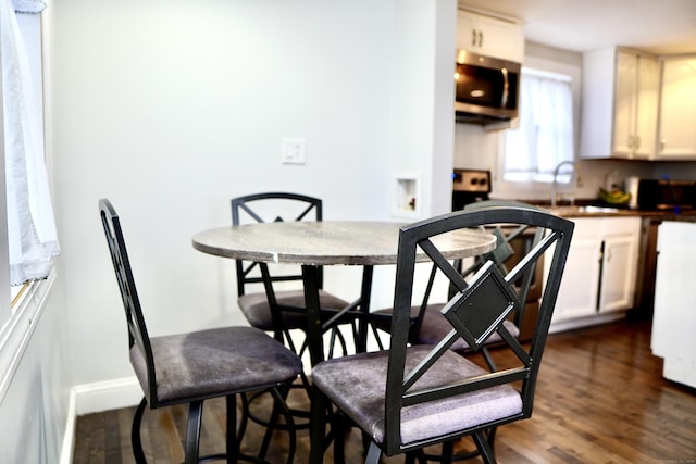 dining room featuring dark hardwood / wood-style flooring and sink