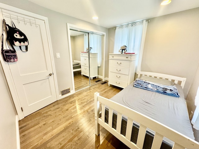 bedroom featuring a closet and light wood-type flooring