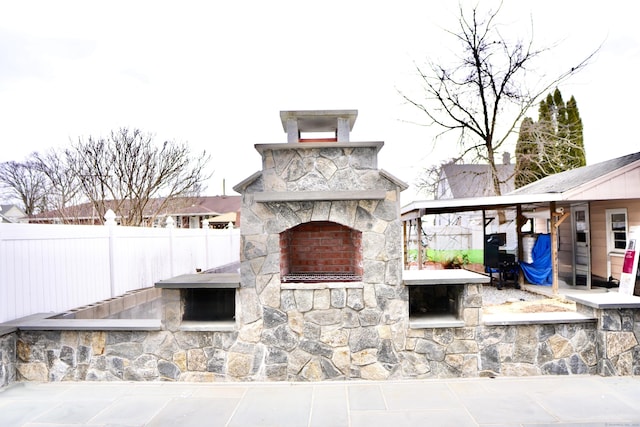 view of patio with an outdoor stone fireplace