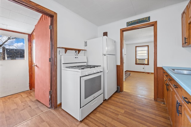 kitchen with cooling unit, light hardwood / wood-style flooring, wooden walls, and gas range gas stove