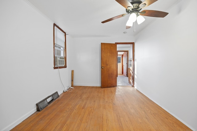 unfurnished room featuring ceiling fan, light hardwood / wood-style flooring, cooling unit, and ornamental molding