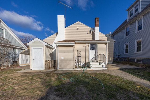 back of property featuring a yard