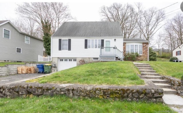 new england style home featuring a garage and a front yard