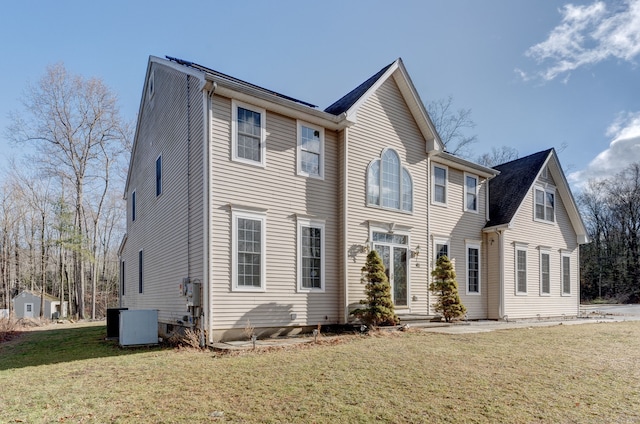 view of front of property featuring central AC and a front lawn