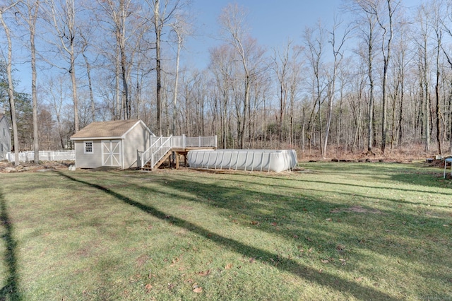 view of yard featuring a pool side deck and a storage unit