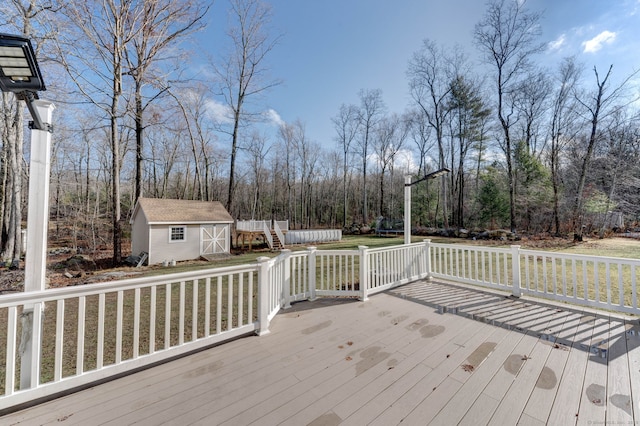 deck with a lawn and a storage shed