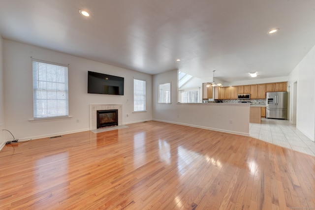 unfurnished living room with a fireplace and light hardwood / wood-style flooring