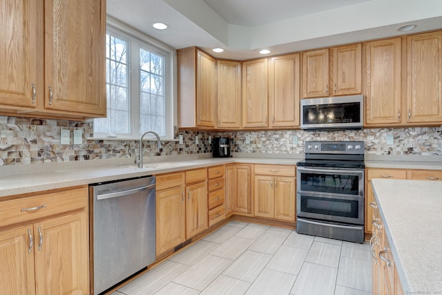 kitchen with backsplash, sink, stainless steel appliances, and light brown cabinets