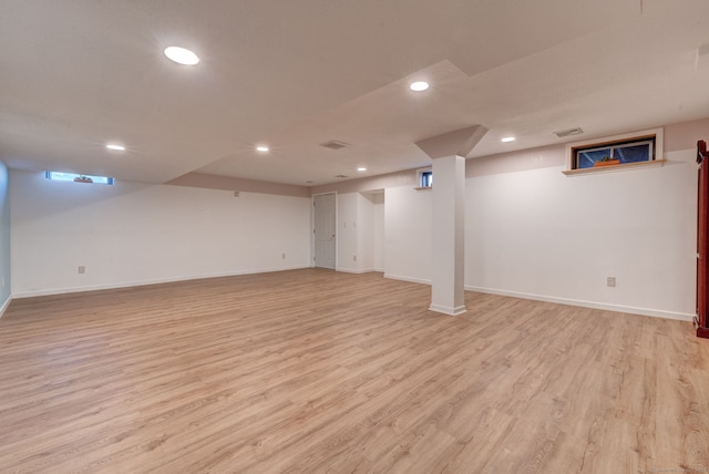 basement with light hardwood / wood-style flooring