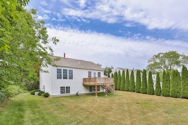 back of house with a deck and a yard