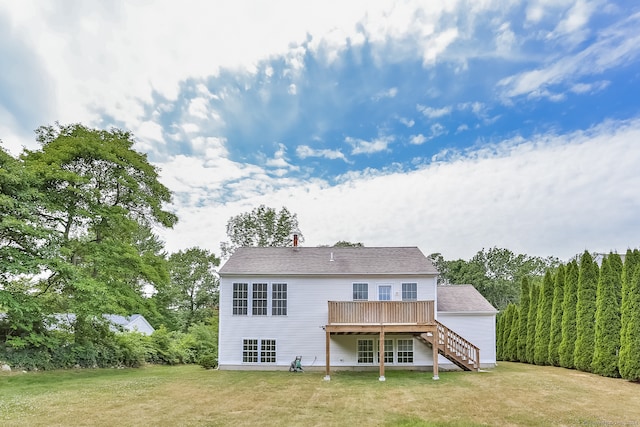 back of house with a deck and a yard