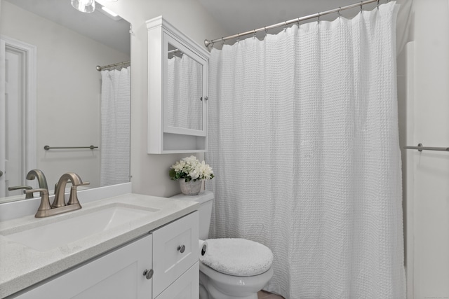 bathroom with toilet and vanity