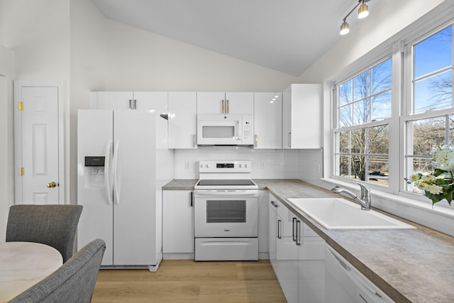 kitchen with backsplash, sink, white appliances, light wood-type flooring, and white cabinets