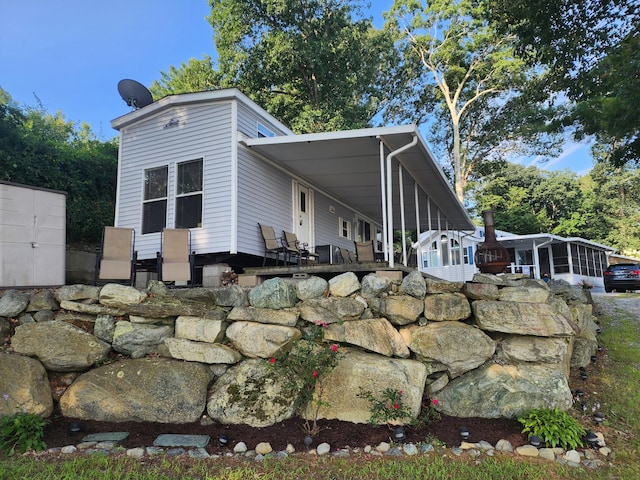 view of side of property with a sunroom